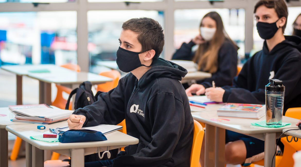 Um tema que vem levantando muitas dúvidas em pais e estudantes sobre cronograma, estrutura e até conteúdos, é o Novo Ensino Médio, que entra em vigor a partir de 2022 . Veja nesse texto o que muda no Colégio Planck para quem está ingressando nesta etapa escolar. Novo Ensino Médio: quais são os principais tópicos? Foi a Lei nº 13.415/2017 que alterou a Lei de Diretrizes e Bases da Educação Nacional, para estabelecer uma mudança na estrutura do Ensino Médio. Nesta alteração ficou definida uma ampliação do tempo mínimo dos estudantes na escola e uma nova organização curricular. A primeira grande alteração para 2022 é que a estrutura pedagógica no Ensino Médio será dividida em 2 partes: a formação geral básica (FGB) e os itinerários formativos e unidades eletivas. O primeiro tem foco nas áreas de conhecimento (Ciências Humanas, Matemática, Linguagens e Ciências da Natureza), que serão obrigatórias para todos os estudantes. Nos itinerários formativos e unidades eletivas estão previstas disciplinas que terão a ver com os seus interesses, acadêmicos e ou profissionais. Essa mudança também oferece um maior protagonismo ao estudante, ao escolher suas áreas eletivas, e também dá a ele uma oportunidade de desenvolver seu projeto de vida, que é uma competência já prevista pela BNCC. Contextualizando a mudança O Colégio Planck já nasceu com um viés contemporâneo, com um DNA tecnológico, e oferece a seus estudantes uma carga eletiva intensa, com mais de 38 disciplinas, divididas em 6 núcleos, que atraem os mais diferentes perfis. Desde o Ensino Fundamental Anos Finais, a bagagem diversificada oferecida pelo Colégio é diferenciada. São aulas como Laboratório Maker, Academia Sherlock, idiomas que apresentam uma carga horária maior, assim como outros projetos que visam a ampliação dos horizontes dos estudantes. A carga extracurricular do Ensino Médio no Colégio Planck conta com disciplinas eletivas como Startup & Empreendedorismo, Maker, Olimpíadas de Conhecimento, PGG, etc. Além disso, o terceiro ano é direcionado também às áreas de conhecimento focadas no vestibular e na definição de carreira, com um processo intenso de simulados e orientação educacional individualizada . Porém, o novo Ensino Médio vai permitir que uma ampliação dessa grade diversificada traga uma outra perspectiva para os estudantes das primeiras e segundas séries. Neste momento, entram novas palavras no vocabulário deles, como itinerários e trilhas. Atualmente, os estudantes da 1ª e 2ª séries do Ensino Médio têm 6 aulas pela manhã (segunda a sexta); provas e atividades complementares e eletivas, que são realizadas no período da tarde. São 30 aulas semanais. A carga atual, então, é de 1.200 horas/aulas por ano, o que também acontece para o 9º ano do Ensino Fundamental. Já na 3ª série do Ensino Médio, a carga é de até 1.440 horas ao ano, porque os estudantes também têm aulas aos sábados. O que acontece a partir de 2022? A partir de 2022, essa carga horária será diferente: para a 1ª e 2ª séries do Ensino Médio, serão 800 horas para a Formação Geral Básica (FGB) e mais 200 horas de itinerários, que serão as trilhas escolhidas pelos estudantes. O que vai ocorrer é que serão 24 horas aula/semanais dedicadas à FGB e seis horas dedicadas para os itinerários. Com essa nova carga, a partir de 2022, a mudança será na sexta-feira de todas as semanas, quando os estudantes irão participar das aulas diversificadas. No entanto, a 3ª série do Ensino Médio não vai sofrer alteração na carga horária, pelo menos até 2023. Como ficam as aulas regulares? Embora tenha havido uma redução de aulas nas áreas de conhecimento específicas, o certo é que no Colégio Planck não haverá prejuízo no conteúdo, que continuará consistente, estruturado e completo. Será uma nova carga com estudo de curadoria. A essência de alto desempenho do Colégio será mantida. Essa nova carga horária vai continuar proporcionando aos estudantes a compreensão dos conteúdos pedagógicos e científicos. Além disso, serão garantidos todos os conteúdos básicos para ENEM, vestibulares do Brasil e applications para universidades internacionais. O que ocorre é que, no formato atual, muitas vezes, os estudantes têm um conteúdo muito detalhado de cada área de conhecimento, mas, nem sempre, essas informações estão associadas aos interesses pessoais de cada um. A mudança do Ensino Médio dá essa liberdade de escolha ao estudante. Nesse novo formato, os estudantes terão uma aula de Projeto de Vida, que será direcionado por profissionais da Orientação Pedagógica e/ou outros profissionais convidados. A aula será desenvolvida em 3 dimensões: Pessoal (autoconhecimento, autoaceitação e autoestima); Social (relações interpessoais); Profissional (mundo profissional). Matriz socioemocional do Planck ganha mais destaque Além do eixo acadêmico e rigor pedagógico, o desenvolvimento socioemocional é um dos pilares do Colégio Planck. Com esse novo formato para o Ensino Médio, essas habilidades e competências, que estão dispostas em 4 eixos, ganham destaque: abertura ao novo, resiliência emocional, autogestão e amabilidade e engajamento. Esse desenvolvimento vai ganhar muita presença nos itinerários formativos e no Projeto de Vida. Para se ter uma ideia de como será esse processo, o Projeto de Vida, que entra na grade da 1ª e 2ª séries do Ensino Médio, será uma aula que tem 3 grandes objetivos, que são: trabalhar o autoconhecimento, desenvolvimento da autonomia e escolhas profissionais e escolhas de futuro. Ao se conhecer, acreditar no próprio potencial e ter um repertório amplo, ele terá um alicerce que vai ajudá-lo a desenvolver os seus sonhos. Essa aula vai ajudar o estudante a conhecer e esclarecer suas dúvidas sobre áreas, aprender a pesquisar sobre carreiras, mercado de trabalho e tendências, para entender mais sobre esses tópicos e para ir ao encontro dos seus sonhos. O trabalho individual da Orientação Educacional permanece, porém, a aula vai trazer soluções de forma coletiva. Como serão os itinerários informativos por áreas de conhecimento? Em relação às aulas que serão oferecidas às sextas, sobre os itinerários informativos, nas áreas de conhecimento, o estudante poderá escolher conteúdos de Matemática, Linguagens, Ciências da Natureza e Ciências Humanas, de acordo com a área que mais se identificar. Os eixos estruturantes dos itinerários formativos não visam ter mais aulas de uma determinada disciplina, não se tratam apenas de mais aulas teóricas, mas sim usar determinadas áreas de conhecimento como alicerce. São aulas que vão responder ao estudante onde ele vai empregar aquele determinado conhecimento em sua vida. Essas trilhas irão estimular o protagonismo dos estudantes e possibilitar o desenvolvimento de aspectos importantes, como: Investigação científica, que vai aprofundar os principais conceitos de cada área; Estimular os processos criativos; Realizar uma mediação e intervenção sociocultural; Empreendedorismo. Focando nestes 4 principais aspectos, esses conteúdos foram criados, em sua maioria, pela equipe pedagógica interna do Planck, e também com um material de apoio do SAS. Nestas aulas não haverá provas, recuperação ou repetência, mas sim a entrega semestral de um projeto, com 3 marcadores de entrega. Essas notas irão compor o histórico do estudante. A cada semestre, o estudante irá escolher uma das áreas de conhecimento, e fazer inscrições em cada um dos pacotes de aulas. Cada área é composta por 3 trilhas, cada uma com 2 horas-aulas. O Planck vai oferecer 24 opções de trilhas anuais e multisseriadas, que vão complementar as diferentes áreas de conhecimento. São: 1º Semestre Matemáticas e suas tecnologias Fechando a conta: desenvolvendo a consciência financeira; Design gráfico; A Matemática da Inteligência Artificial. Humanidades e suas tecnologias Mundo em movimento: explorando fatos e contextos; Cidadania e direitos fundamentais; História do pensamento humano. Ciências da Natureza e suas tecnologias Ambiente-se: escolhas de hoje para viver o amanhã; Sustentabilidade e desenvolvimento de materiais; Circuito elétricos na prática. Linguagens e suas tecnologias Muito além da influência: argumentação na linguagem; Design de interiores; Revelando mais que a escrita. 2º Semestre Matemáticas e suas tecnologias Problemas em cheque: táticas de resoluções; Processo de decisão e lógicas cotidianas; Funções no mundo: métricas e relações. Humanidades e suas tecnologias Empreendedores Under 20; Constituição e poderes; Políticas públicas (Unesco). Ciências da Natureza e suas tecnologias Investigação forense; Química dos alimentos; História da Ciência. Linguagens e suas tecnologias Strike a pose: nossa vida em rede; Escrita criativa; Sustentabilidade maker (design de móveis). Inscrições para as trilhas começam em novembro Para que os estudantes saibam mais sobre os conteúdos de cada trilha, o Colégio Planck fará uma campanha de divulgação. As inscrições para os itinerários formativos para o primeiro semestre do ano que vem começam já em novembro deste ano. Para o segundo semestre, as inscrições serão em junho de 2022. Cada estudante pode realizar duas áreas iguais ou distintas por ano. No entanto, a escolha precisa ser bem pensada, porque ele não poderá mudar de trilha ao longo do semestre. Vale lembrar que todos os projetos pedagógicos do Colégio Planck, inclusive as atividades eletivas, seguem com sua realização normal, no contraturno das aulas. Conclusão As mudanças que vão ocorrer para o Novo Ensino Médio prometem uma nova dinâmica, porém, com um clima mais leve e descontraído para as sextas-feiras do Colégio. Dentro dessa nova rotina, ocorrerá também maior interação entre as séries, porque durante as trilhas, os estudantes das turmas do 1o e 2o anos estarão em turmas mistas. Além disso, o Novo Ensino Médio do Planck trará mais oportunidades de gerar encantamento nos estudantes, mais colaboração e engajamento nas atividades que norteiam escolhas profissionais e o Colégio vai atuar também como um instrumento de integração com a realidade. Em qualquer mudança no Colégio, o objetivo da equipe Planck é sempre trazer a inovação que vai proporcionar o melhor desenvolvimento de seus estudantes.