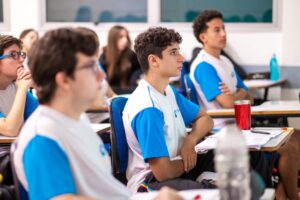 Estudantes concentrados na sala de aula.